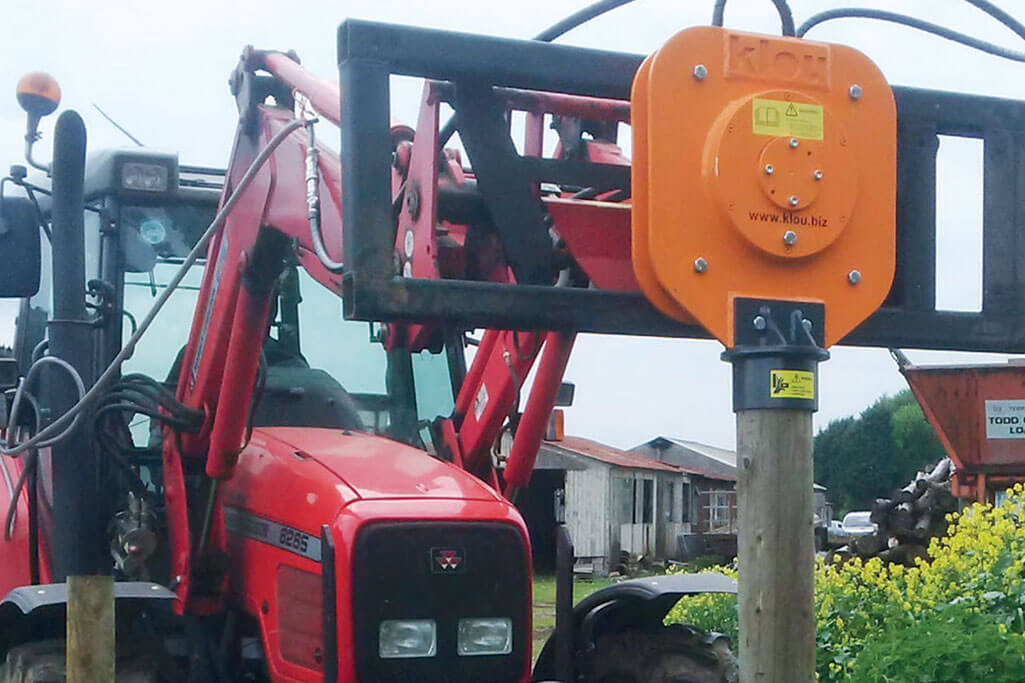 Post driver mounted on a tractor